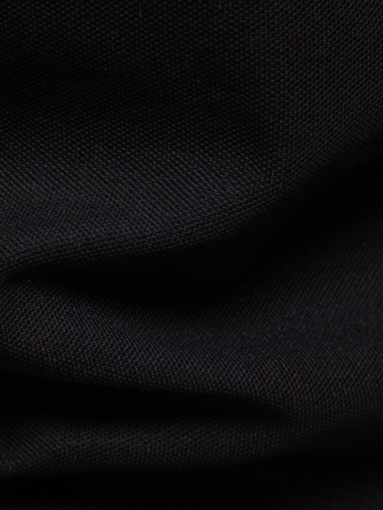 Polo negro de tejido tipo piqué, textura visible.