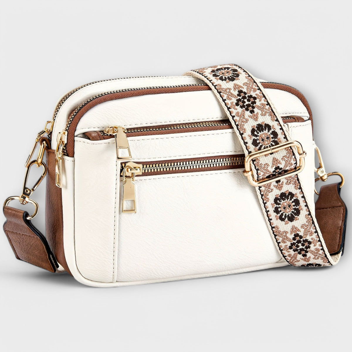 Bolso bandolera retro blanco con correa estampada floral y compartimento frontal con cremallera