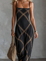 Vestido maxi negro con tirantes finos y estampado geométrico dorado