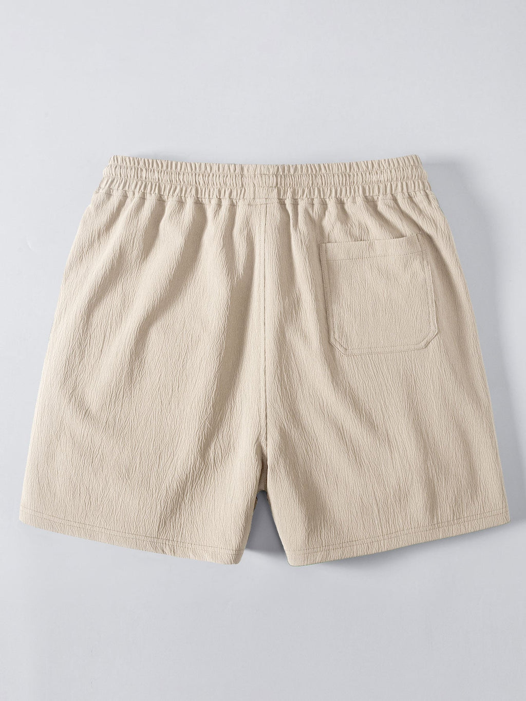 Pantalón corto beige con cintura elástica y bolsillo trasero en la pierna