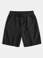 Pantalones cortos de jacquard geométrico negro con cintura elástica y cordón