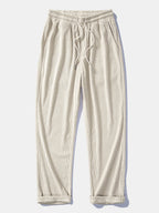 Pantalón recto de pana beige claro, cintura elástica con cordón y bolsillos.