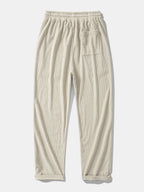Pantalón recto de pana beige, cintura elástica con cordón y bolsillos laterales.