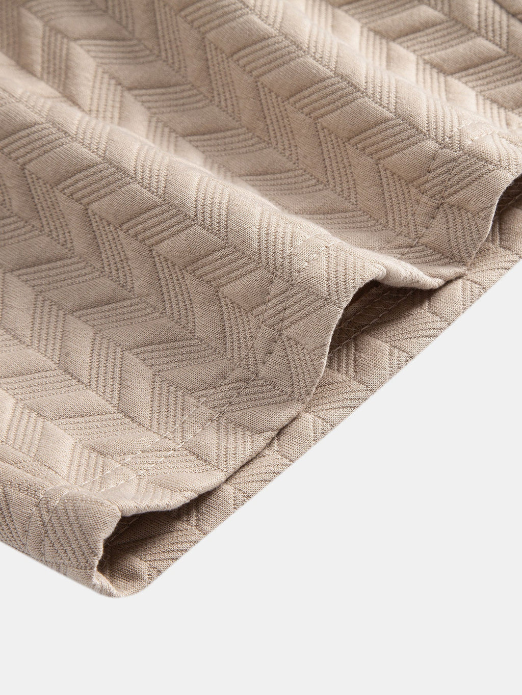 Tejido de jacquard geométrico crema con textura en rombos