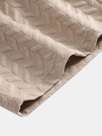 Tejido de jacquard geométrico crema con textura en rombos