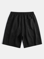 Pantalón corto Capri negro con cintura elástica, cordón y textura en relieve