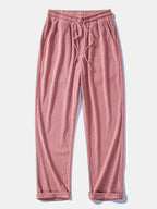 Pantalón recto de pana rosa claro, cintura elástica con cordón y bolsillos laterales.