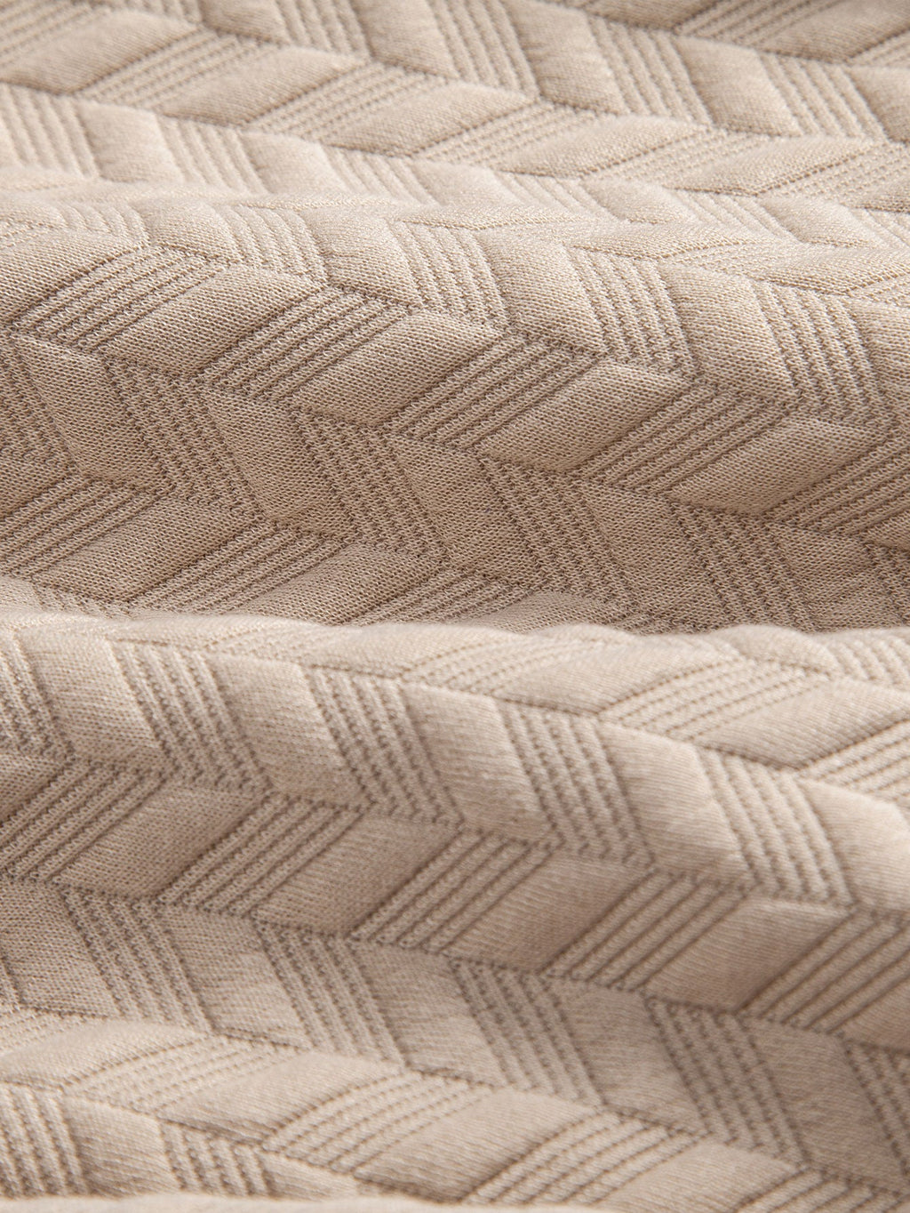 Tejido de jacquard geométrico beige con relieve tipo rombos