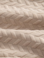 Tejido de jacquard geométrico beige con relieve tipo rombos