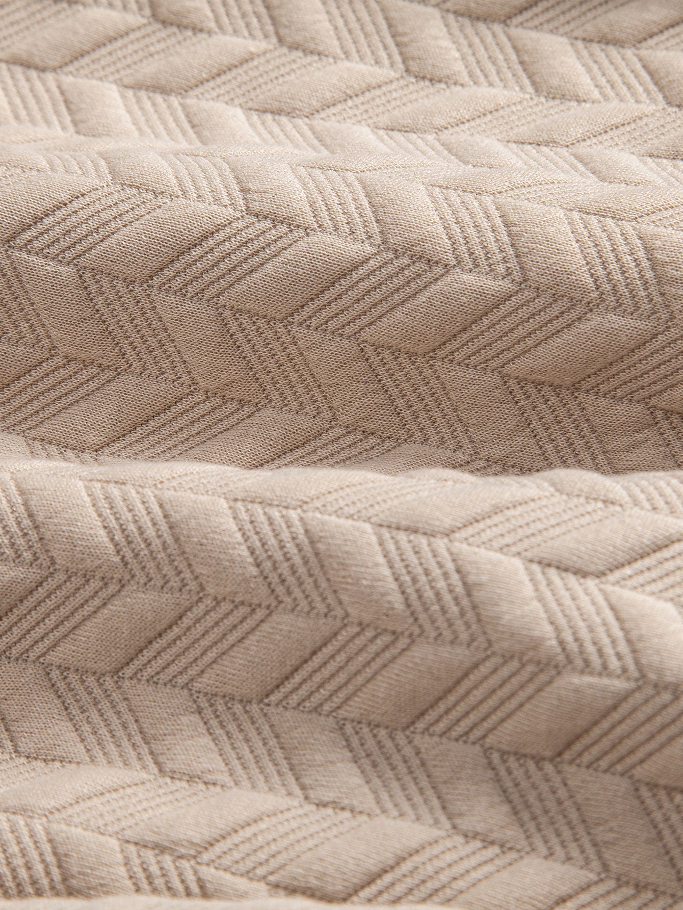 Tejido de jacquard geométrico beige con relieve tipo rombos