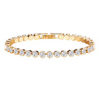 Pulsera tipo tenis dorada con pedrería circular y cierre