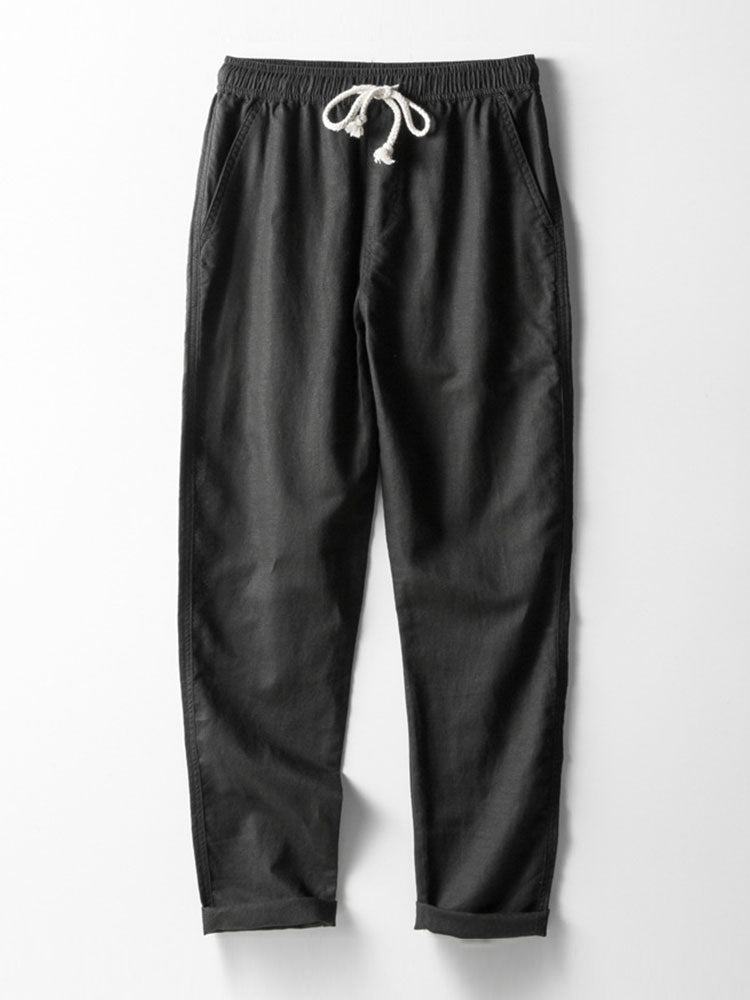 Pantalón recto de lino negro con pretina elástica y cordón blanco