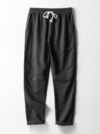 Pantalón recto de lino negro con pretina elástica y cordón blanco