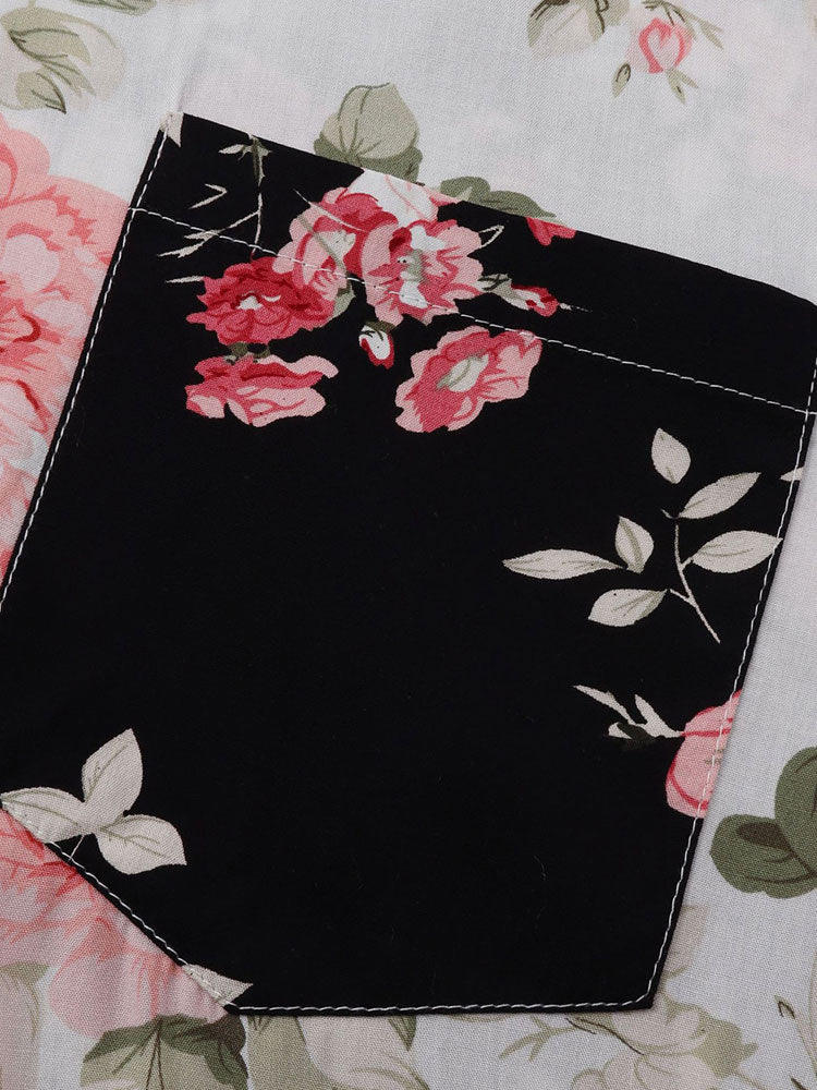 Detalle de panel negro con estampado floral y borde cosido sobre tela clara