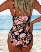 Traje de baño negro de una pieza, espalda en V, estampado floral rosa y crema.