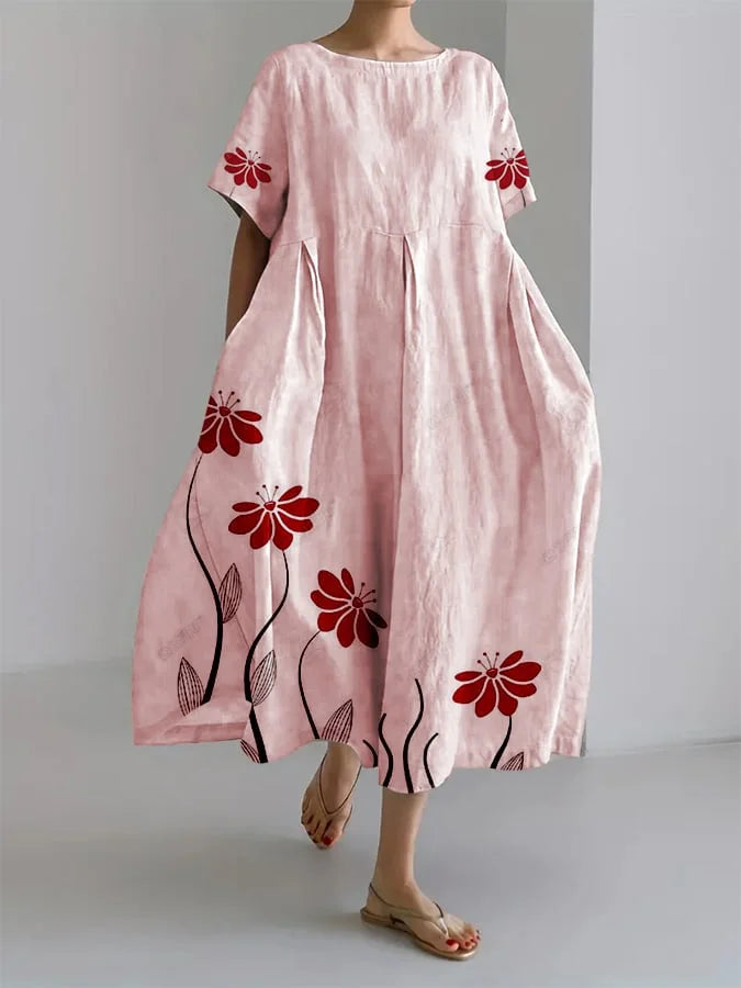 Vestido fluido rosa con estampado floral rojo, manga corta y falda con vuelo