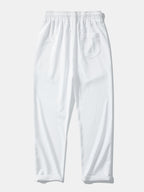 Pantalón recto texturizado blanco con bolsillo lateral y cintura elástica con cordón.