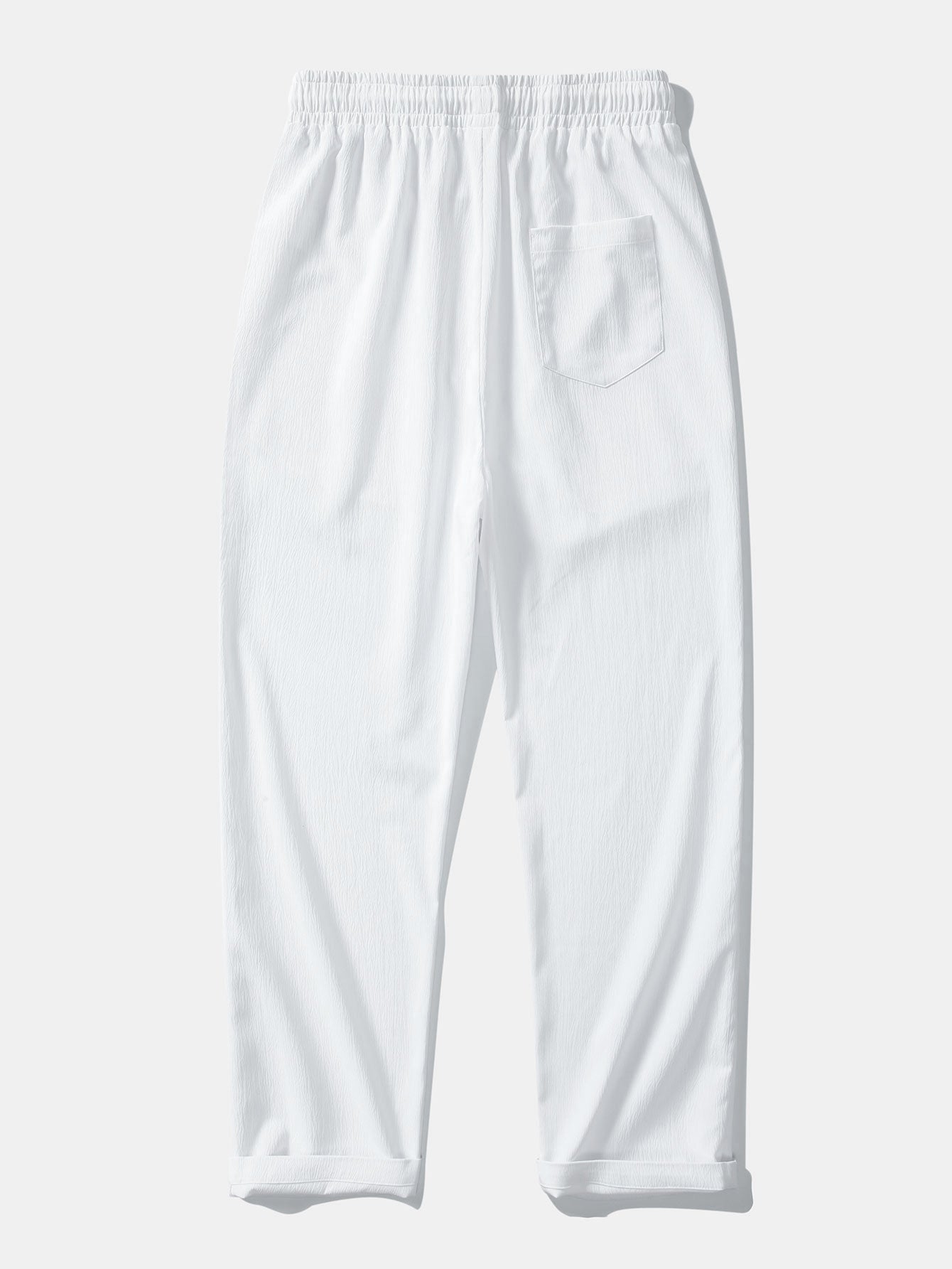 Pantalón recto texturizado blanco con bolsillo lateral y cintura elástica con cordón.