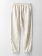 Pantalones de lino crema de corte recto, cintura elástica y dobladillo visible