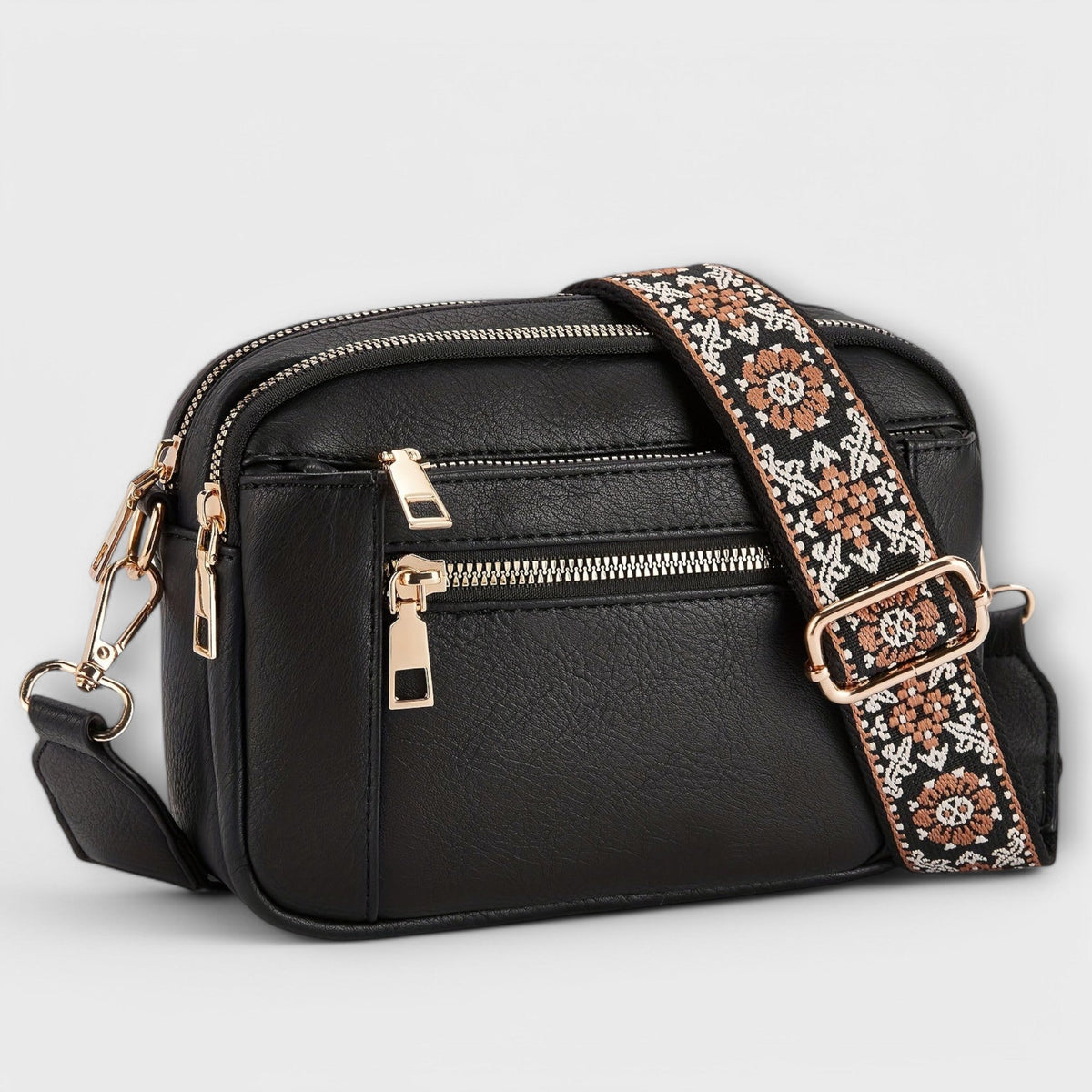Bolso bandolera retro negro con correa estampada floral y cierre con cremalleras