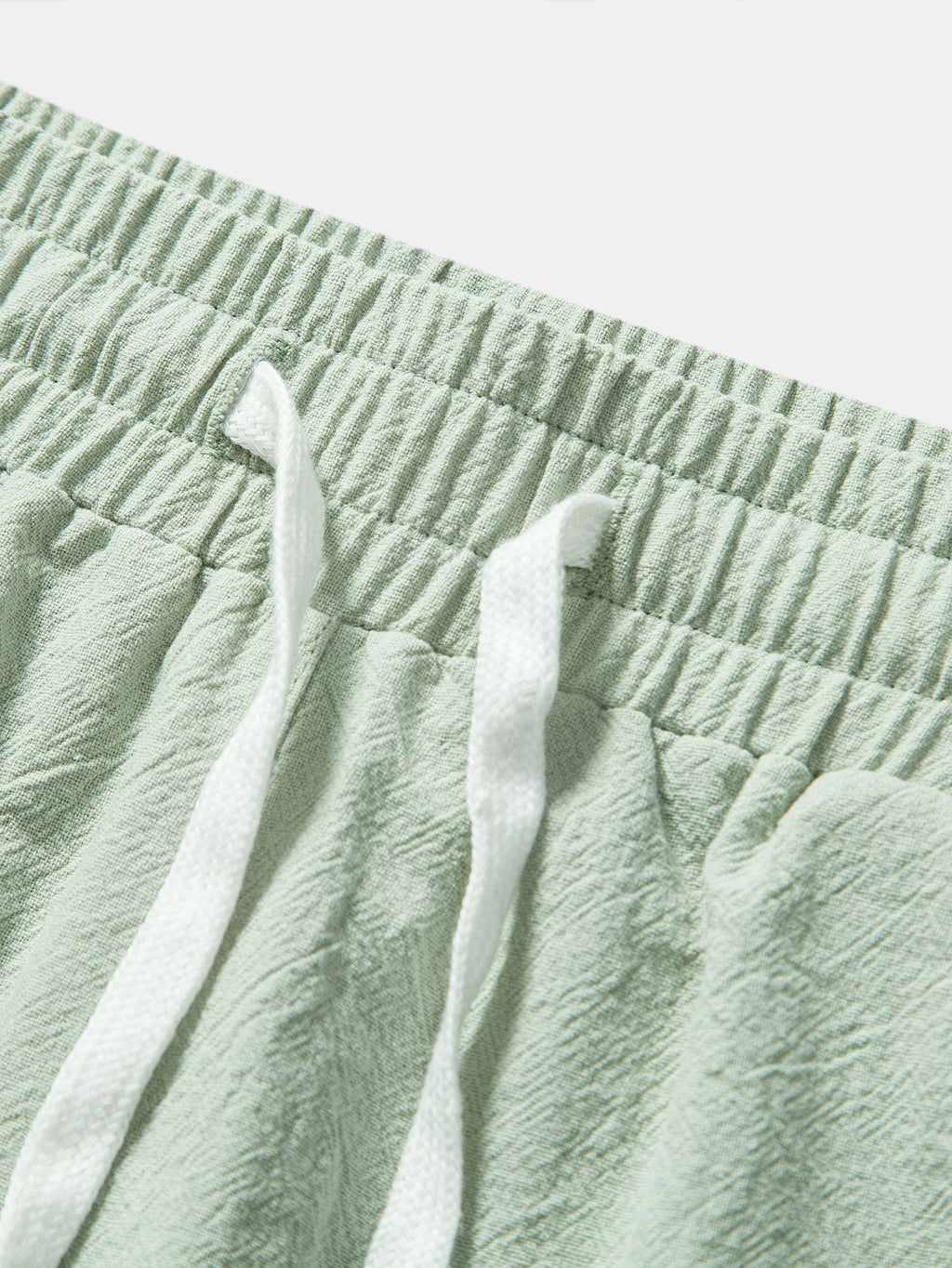 Pantalones cortos de algodón texturizado verde con cintura elástica y cordón