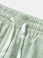 Pantalones cortos de algodón texturizado verde con cintura elástica y cordón