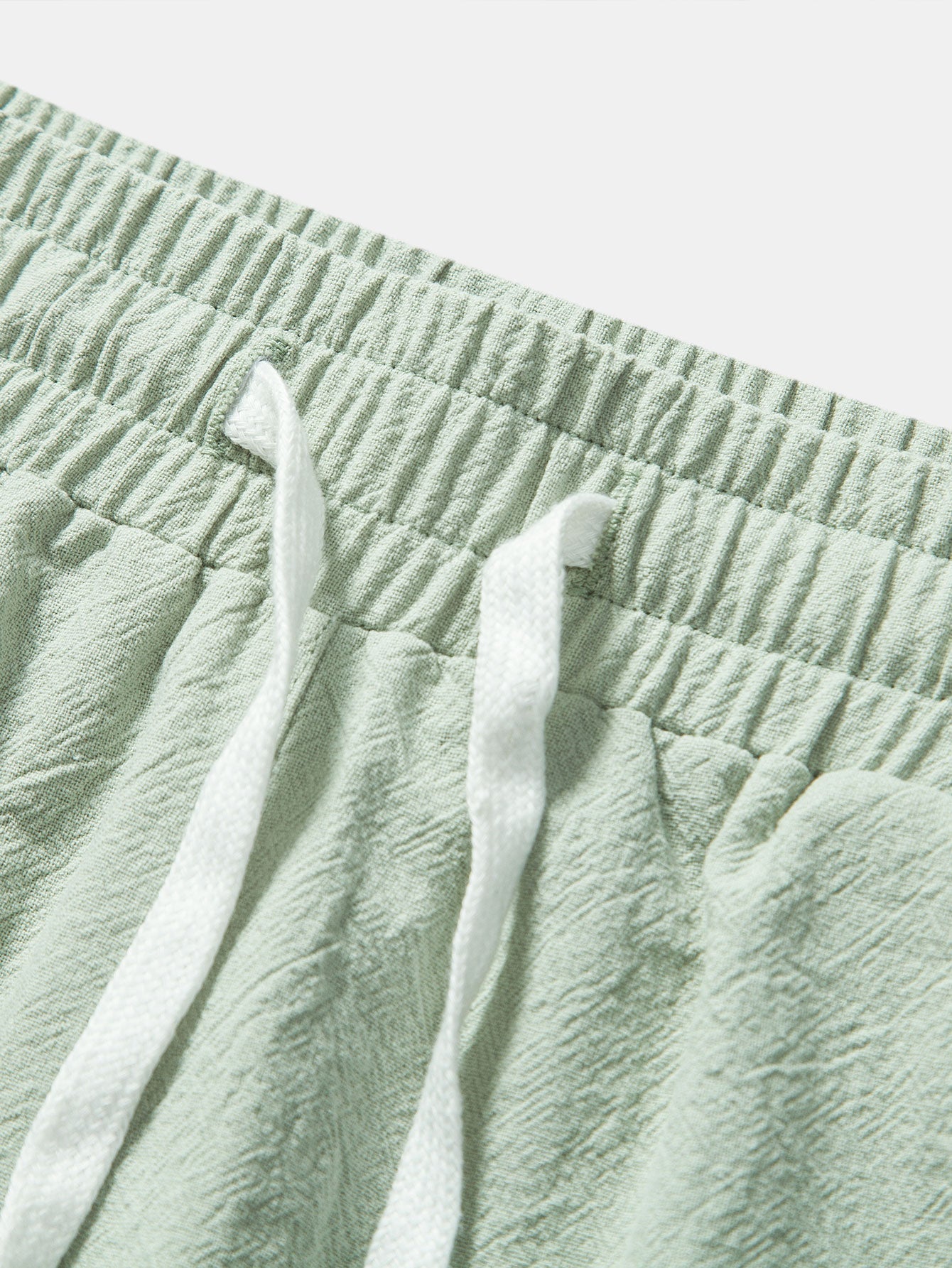 Pantalones cortos de algodón texturizado verde con cintura elástica y cordón