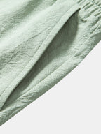 Pantalones cortos de algodón texturizado verde con costura y pliegues