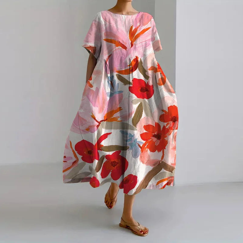 Vestido fluido rosa con flores coral y hojas verdes, mangas anchas y vuelo