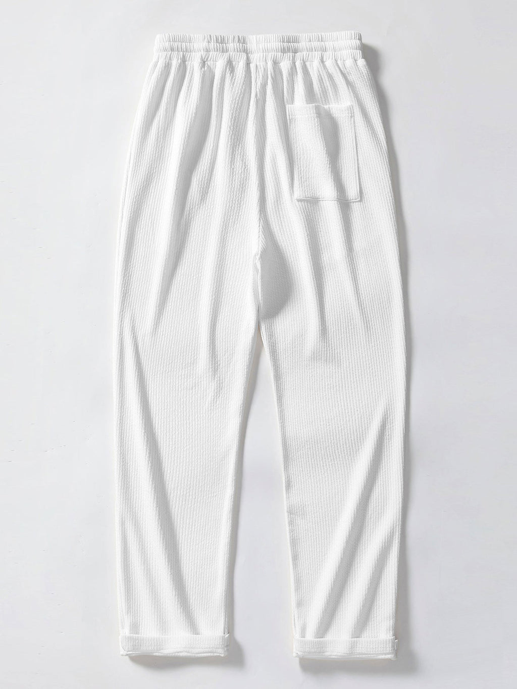 Pantalones rectos blancos acanalados con cintura elástica y bolsillos laterales