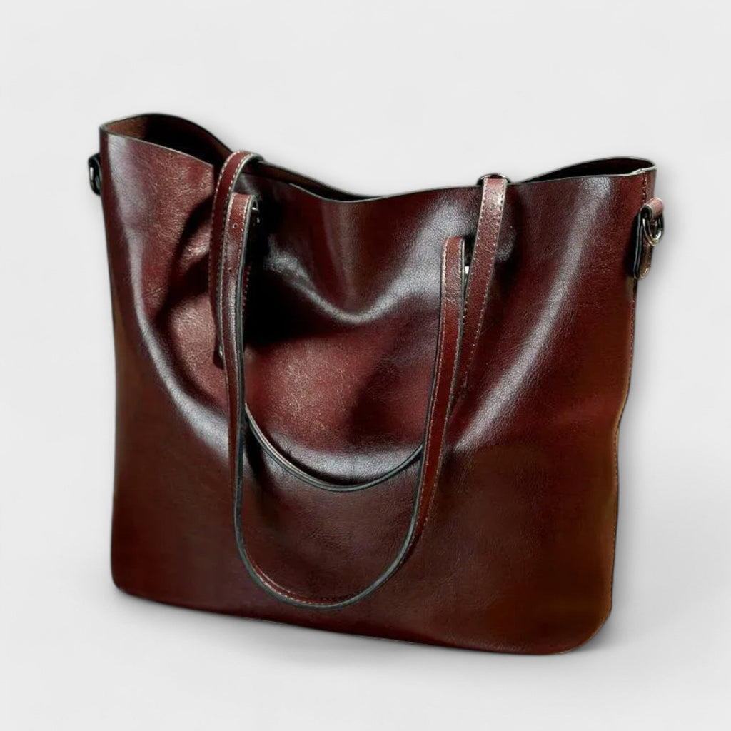 Bolso Tavrèa burdeos con doble asa y bandolera, detalles de costura