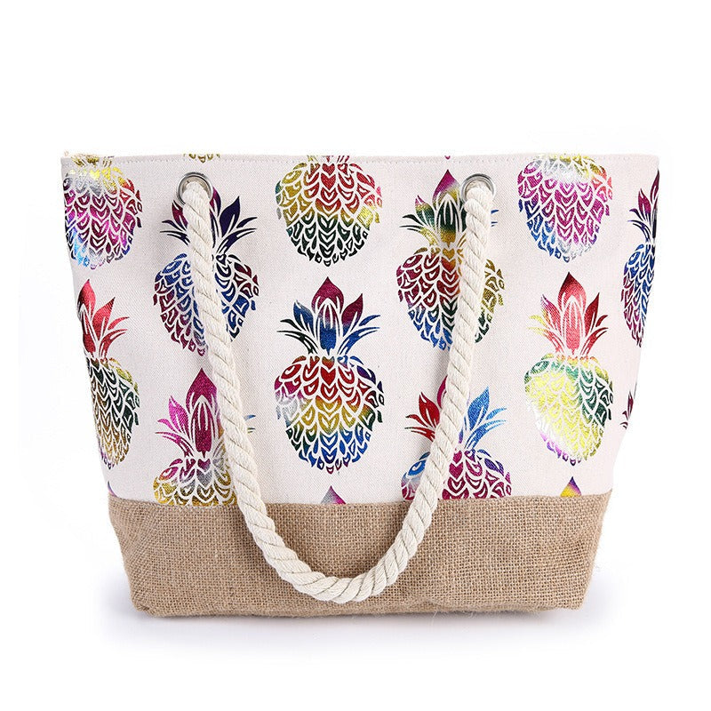 Bolso tote de tela beige con asas trenzadas y estampado multicolor de piñas