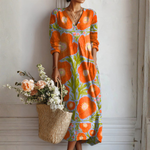 Vestido midi naranja con estampado floral verde, cuello V y mangas 3/4