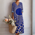 Vestido midi azul con estampado geométrico y cuello en V, mangas 3/4 abullonadas