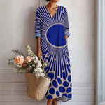 Vestido midi azul con estampado geométrico y cuello en V, mangas 3/4 abullonadas