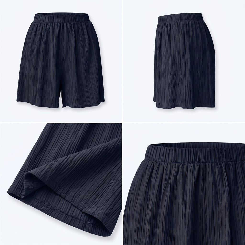 Shorts azul marino plisados con cintura elástica y bajo redondeado, detalle de tela