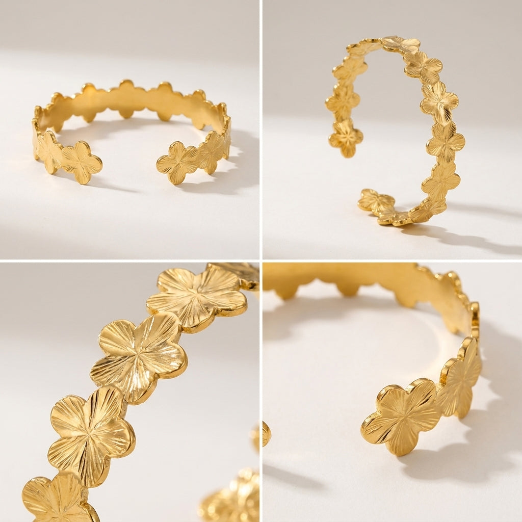 Brazalete dorado con banda abierta y flores de cuatro pétalos alrededor
