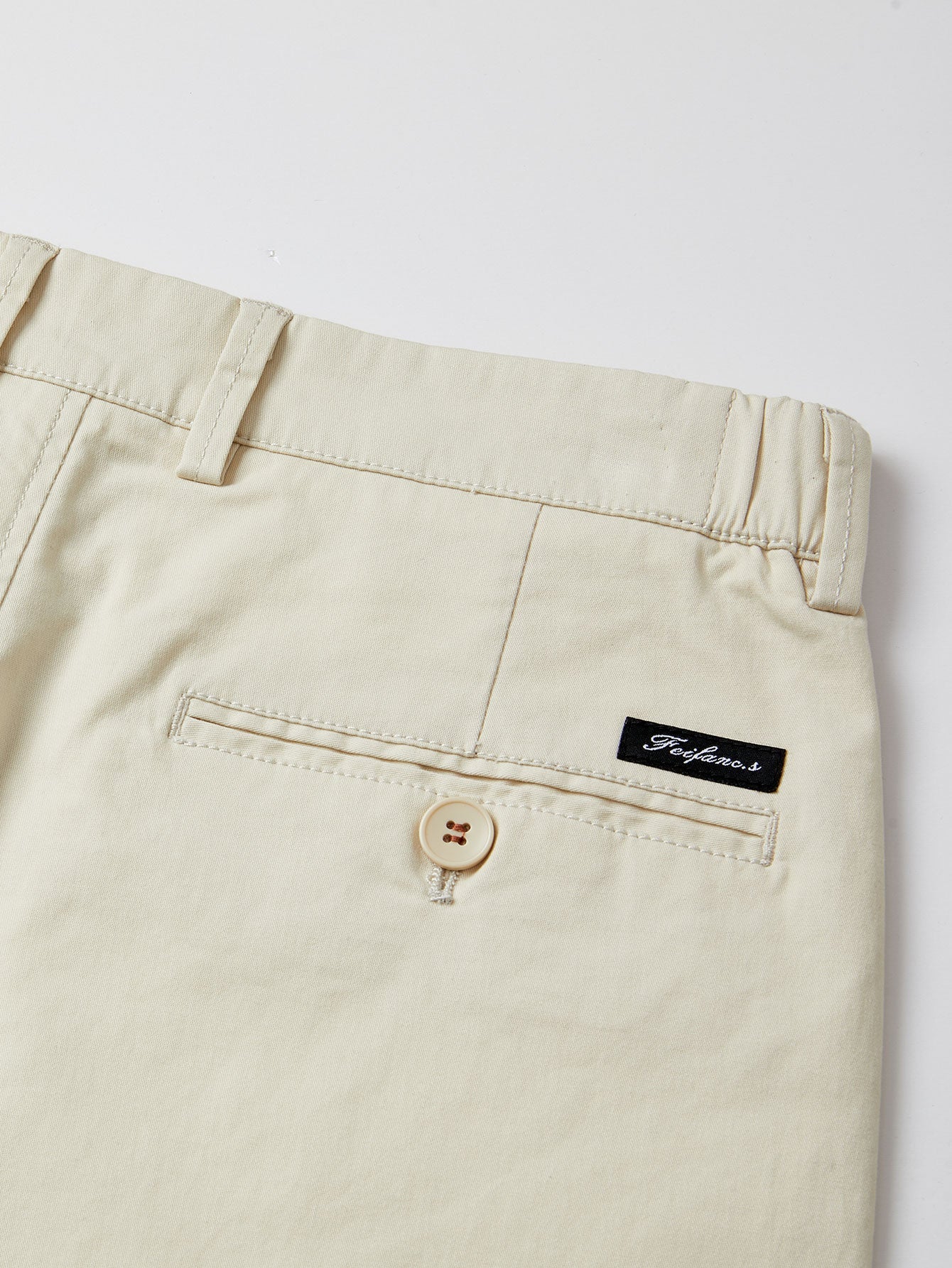 Pantalón corto beige con cinturilla elástica, botón y etiqueta interior