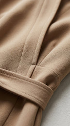 Tela del mono beige con costuras y detalle del cinturón con lazo