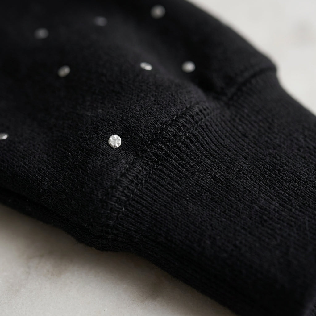 Conjunto de punto negro con lunares brillantes, detalle de costura y botones