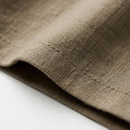 Tela de lino beige con costuras visibles y textura tejida