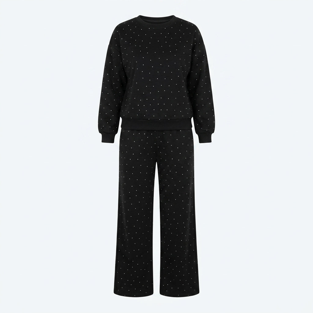 Conjunto de suéter y pantalón negro con brillo sutil; pantalón ancho con cordón.