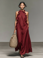Vestido largo de lino rojo oscuro con volantes en el escote tipo halter y sin mangas.