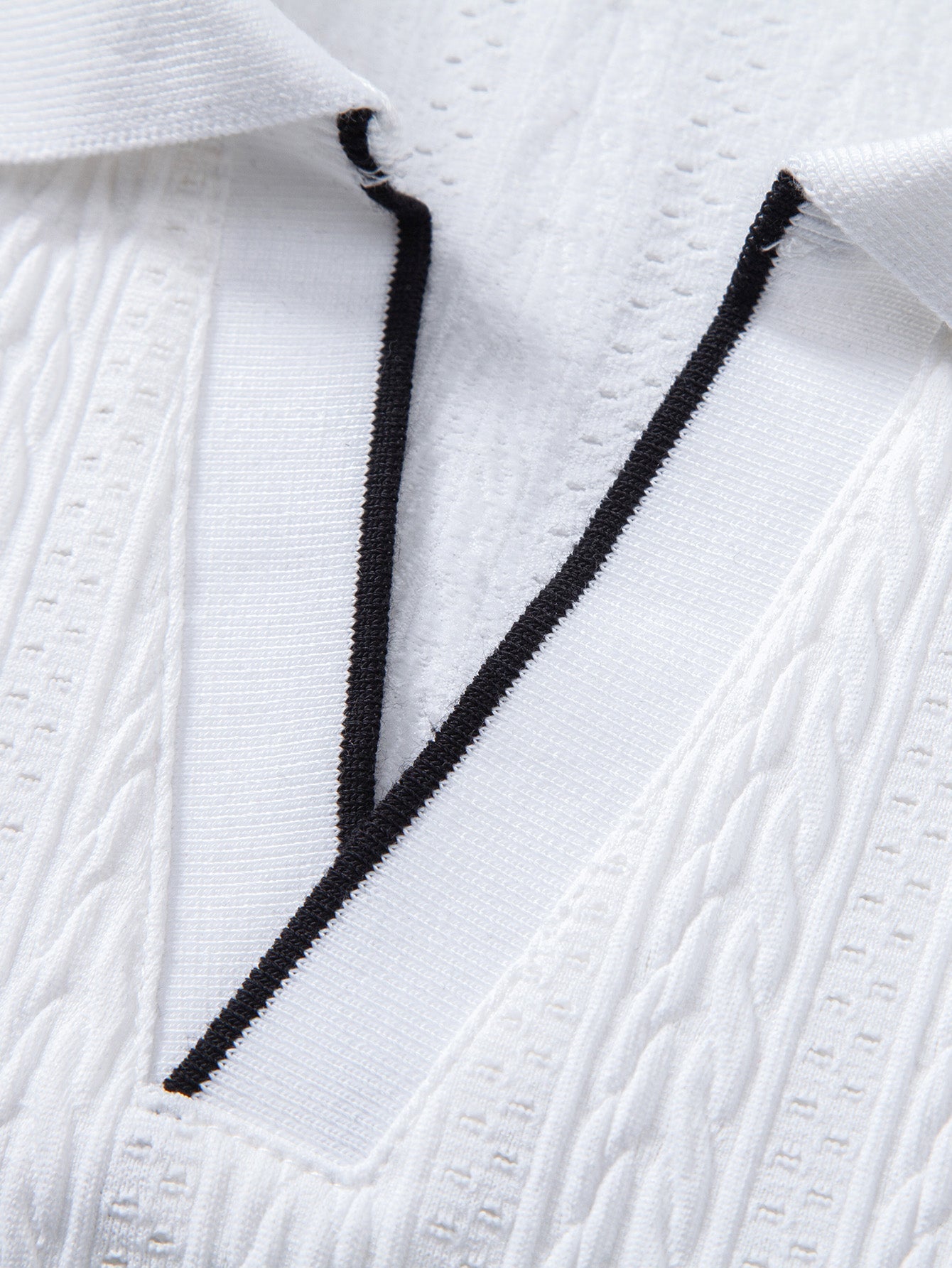 Polo blanco con vivo negro en solapa y textura de jacquard