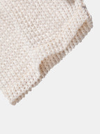 Bajo del polo beige de punto calado con remate tejido y borde vuelto