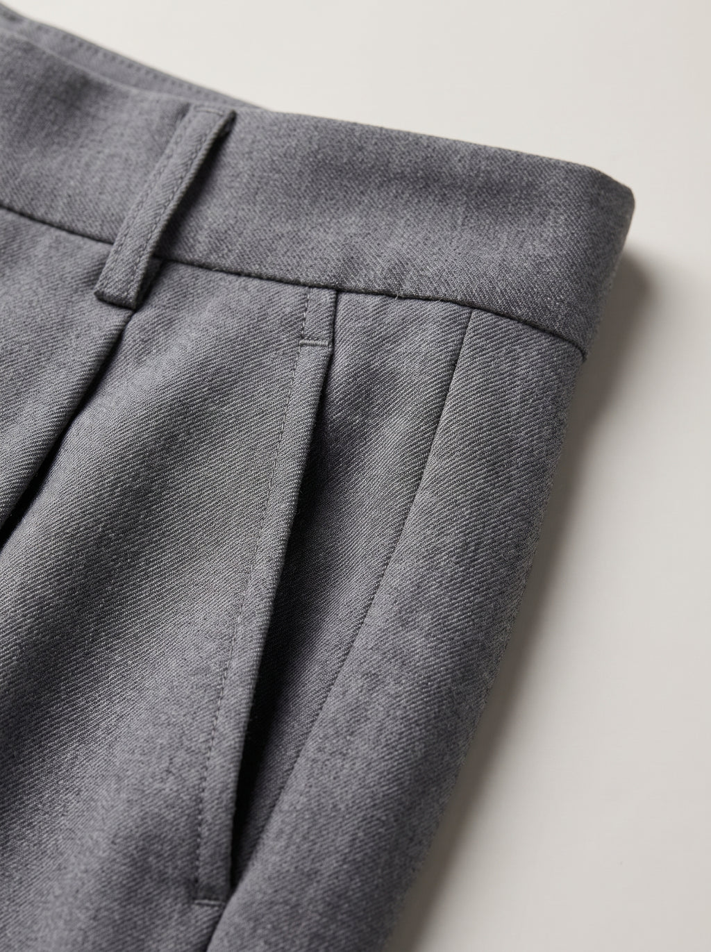 Pantalón sastre Siena gris: detalle de costuras y pliegue en la cintura