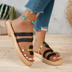 Sandalias Vega con tiras negras, hebillas doradas y suela esparto trenzada