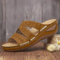 Sandalias de tiras color camel con cuña, bordado floral calado y costuras blancas