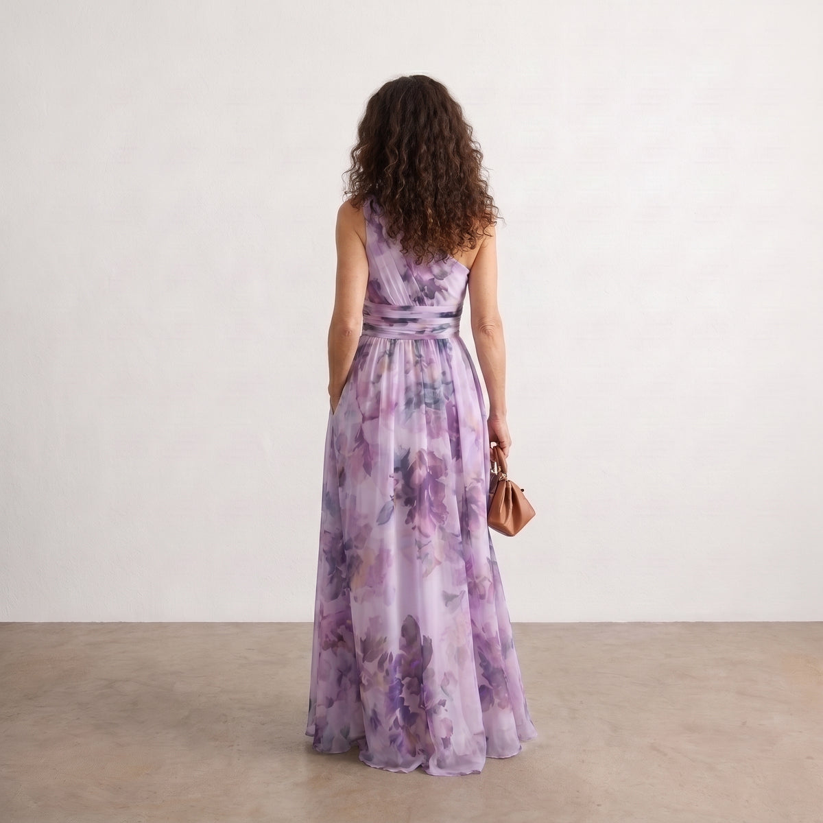 Vestido largo estampado asimétrico con espalda descubierta, tonos lila y morado.