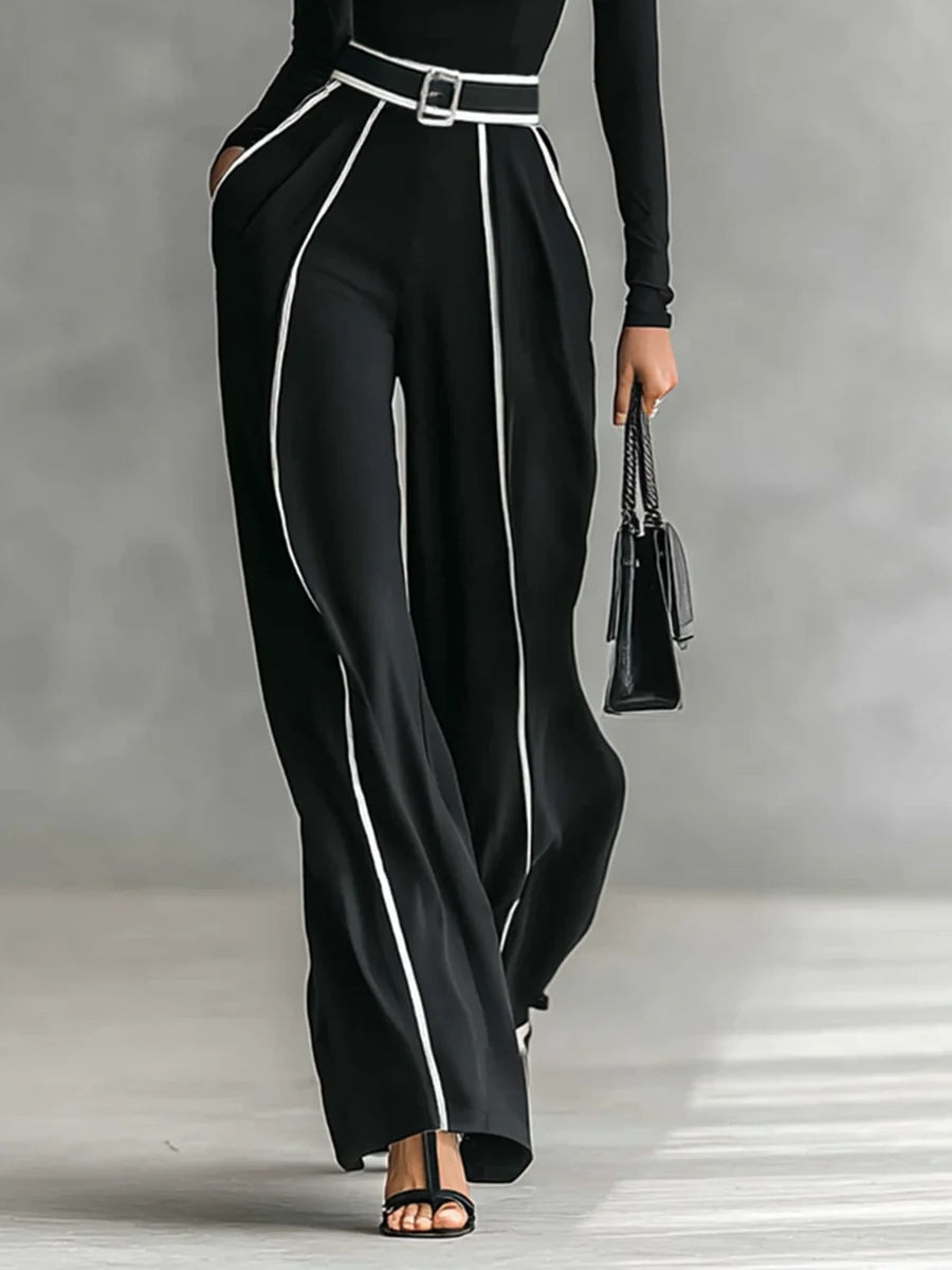 Conjunto negro con pantalón de pierna ancha y cinturón, franja blanca vertical